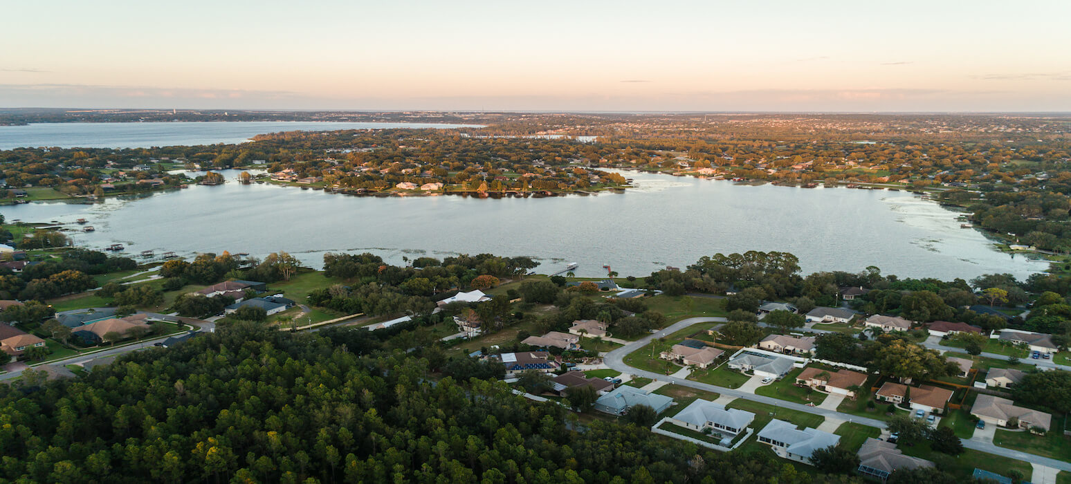 Beautiful waterway lined with trees and waterfront homes in Clermont, Florida